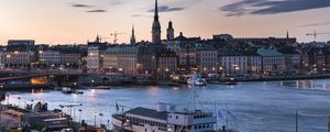 Preview wallpaper towers, buildings, lights, river, boat, twilight