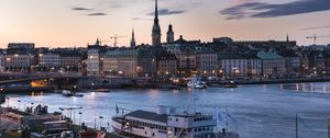 Preview wallpaper towers, buildings, lights, river, boat, twilight