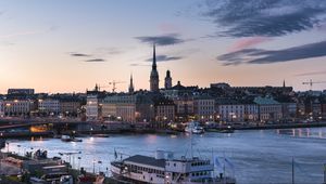Preview wallpaper towers, buildings, lights, river, boat, twilight