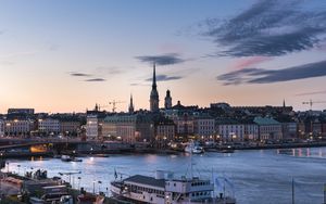 Preview wallpaper towers, buildings, lights, river, boat, twilight