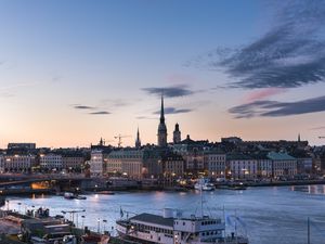 Preview wallpaper towers, buildings, lights, river, boat, twilight