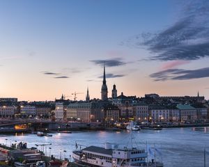 Preview wallpaper towers, buildings, lights, river, boat, twilight