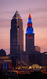Preview wallpaper towers, buildings, lights, city, twilight
