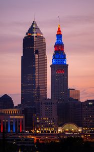 Preview wallpaper towers, buildings, lights, city, twilight