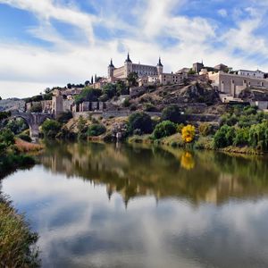 Preview wallpaper towers, buildings, shore, river, reflection