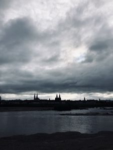 Preview wallpaper towers, buildings, silhouettes, river, evening