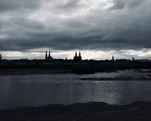Preview wallpaper towers, buildings, silhouettes, river, evening