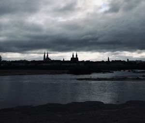 Preview wallpaper towers, buildings, silhouettes, river, evening