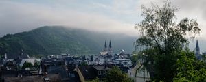 Preview wallpaper towers, houses, mountains, fog, city