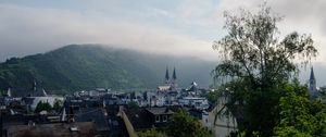 Preview wallpaper towers, houses, mountains, fog, city