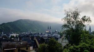 Preview wallpaper towers, houses, mountains, fog, city