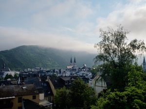 Preview wallpaper towers, houses, mountains, fog, city