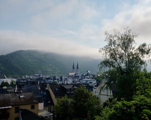 Preview wallpaper towers, houses, mountains, fog, city