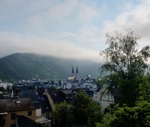 Preview wallpaper towers, houses, mountains, fog, city