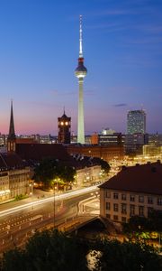 Preview wallpaper towers, houses, road, lights, night, city