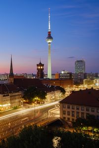 Preview wallpaper towers, houses, road, lights, night, city