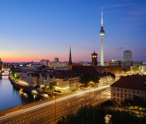 Preview wallpaper towers, houses, road, lights, night, city