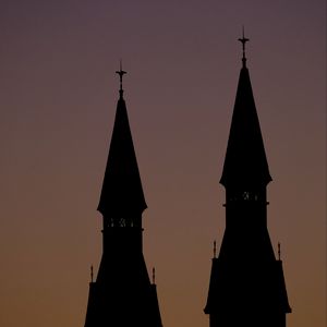 Preview wallpaper towers, silhouettes, evening, sunset, dark