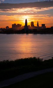 Preview wallpaper towers, skyscrapers, silhouettes, sea, sunset, dark