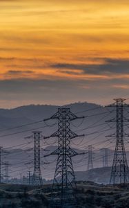 Preview wallpaper towers, wires, mountains, sky, sunset