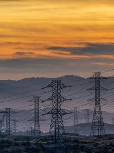 Preview wallpaper towers, wires, mountains, sky, sunset