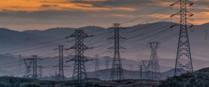 Preview wallpaper towers, wires, mountains, sky, sunset