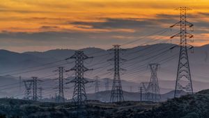 Preview wallpaper towers, wires, mountains, sky, sunset