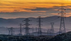 Preview wallpaper towers, wires, mountains, sky, sunset