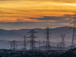 Preview wallpaper towers, wires, mountains, sky, sunset