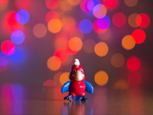 Preview wallpaper toy, parrot, bokeh, glare