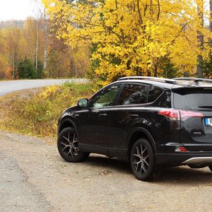 Preview wallpaper toyota, car, black, road, trees, autumn