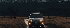 Preview wallpaper toyota, car, suv, front view, rocks, road