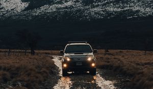 Preview wallpaper toyota, car, suv, front view, rocks, road