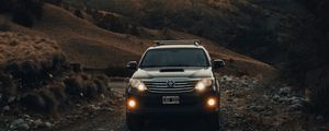 Preview wallpaper toyota, car, suv, front view, road, rock, sky