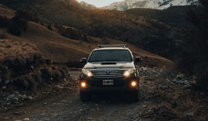 Preview wallpaper toyota, car, suv, front view, road, rock, sky