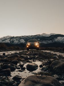 Preview wallpaper toyota, vehicle, suv, front view, road, rocks, headlights