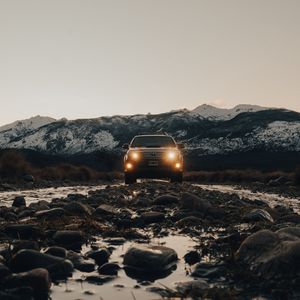 Preview wallpaper toyota, vehicle, suv, front view, road, rocks, headlights