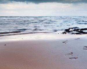 Preview wallpaper traces, person, life, coast, beach, sand, sky, cloudy