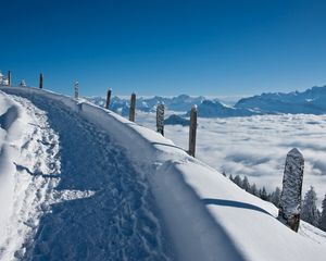 Preview wallpaper track, road, lifting, snow, winter, mountains, stakes