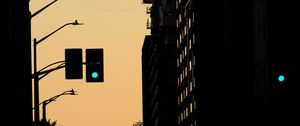 Preview wallpaper traffic light, construction crane, buildings, evening, silhouettes