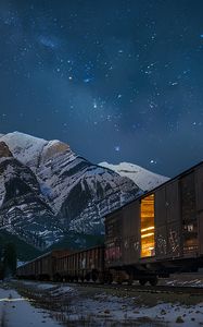 Preview wallpaper train, cars, light, mountains, snow, evening