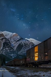 Preview wallpaper train, cars, light, mountains, snow, evening