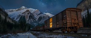 Preview wallpaper train, cars, light, mountains, snow, evening