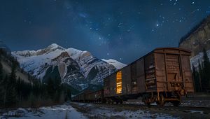 Preview wallpaper train, cars, light, mountains, snow, evening