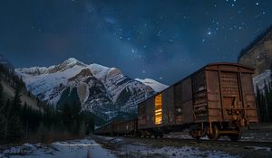 Preview wallpaper train, cars, light, mountains, snow, evening