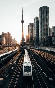 Preview wallpaper train, rails, city, buildings, sunset