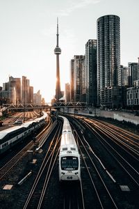 Preview wallpaper train, rails, city, buildings, sunset