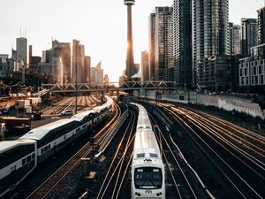 Preview wallpaper train, rails, city, buildings, sunset
