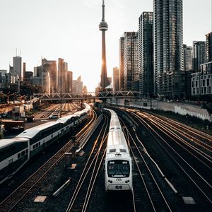 Preview wallpaper train, rails, city, buildings, sunset