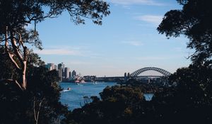 Preview wallpaper trees, buildings, city, river, boats, sky